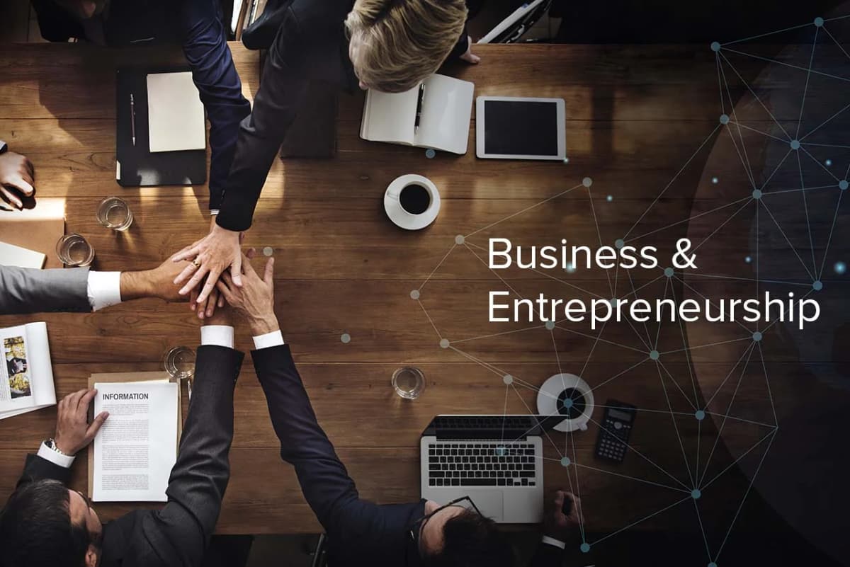 A lightbulb glowing over a business plan, symbolizing entrepreneurship.