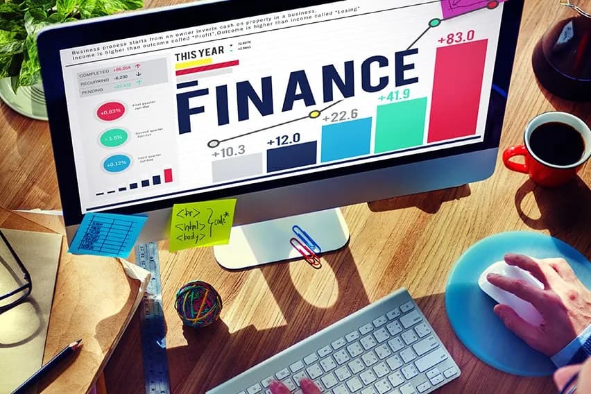 Financial charts, a calculator, and coins representing accounting.